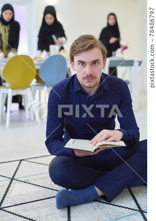 Young muslim man reading Quran during Ramadan Young muslim man reading Quran during Ramadan 78486797