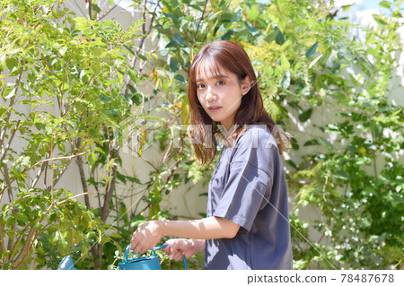 Woman watering on the terrace 78487678