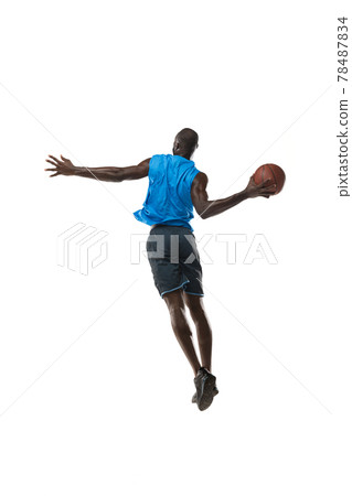 Full length portrait of a basketball player with a ball isolated on white studio background. advertising concept. Fit african american athlete jumping with ball. 78487834
