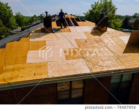 Construction worker on renovation roof the house installed new shingles Construction worker on renovation roof the house installed new shingles 78487958