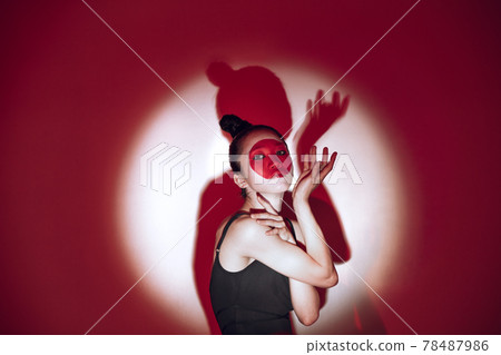 Ballet dancer dancing over red studio background. Modern design. Contemporary colorful conceptual light as rising sun at Japan. 78487986