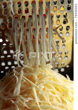 Grated cheese and grater. Grated cheese and grater. 78490083
