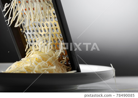 Grated cheese and grater. 78490085