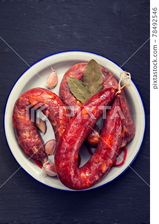 Portuguese smoked sausages Chourico on white dish Portuguese smoked sausages Chourico on white dish 78492546