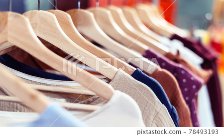 Summer cotton handmade dresses hang on a hanger in the store. Summer cotton handmade dresses hang on a hanger in the store. 78493193