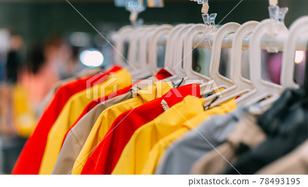 autumn-spring jackets of different colors hang on a hanger in the store autumn-spring jackets of different colors hang on a hanger in the store 78493195