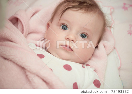 cute little baby in bed trying to sleep 78493582