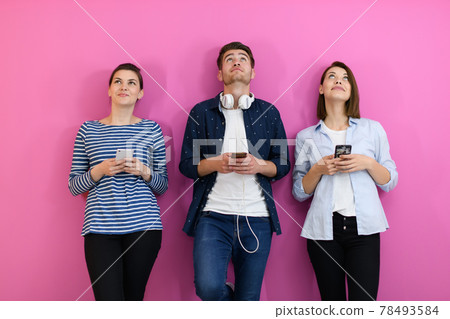 group of friends have fun and dance while using a cell phone and headphones 78493584