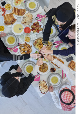 Top view of muslim family having Iftar during Ramadan holy month Top view of muslim family having Iftar during Ramadan holy month 78493669