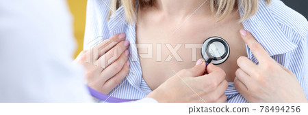 Doctor listening to patient's lungs with stethoscope 78494256