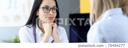 Portrait of doctor listening to patient at appointment 78494277