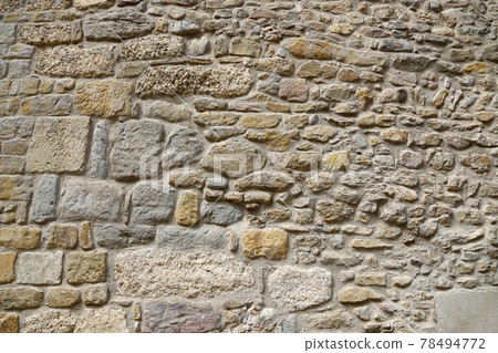 Very ancient stone wall, closeup texture 78494772