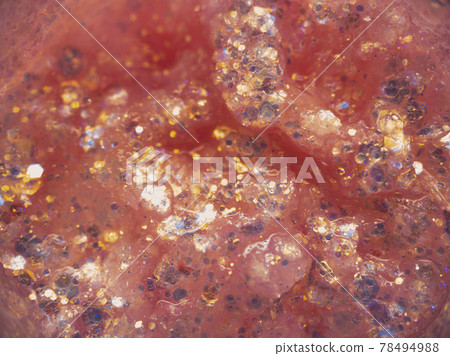 Pink glitter texture, small multi-colored decorative sequins for festive makeup or to be applied to nails.  Beauty concept. 78494988