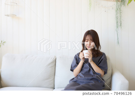 Woman relaxing in the living room Woman relaxing in the living room 78496126