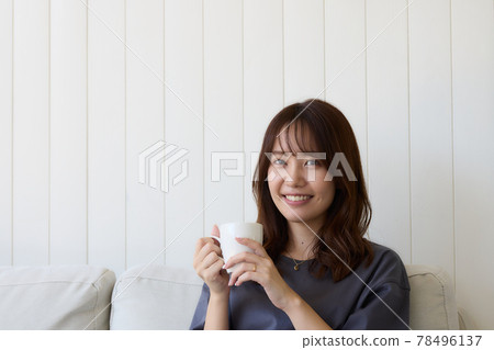 Woman relaxing in the living room 78496137