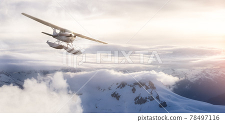 Airplane flying near the Beautiful Canadian Mountain Nature Landscape. 78497116