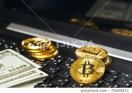 Bitcoins coin and banknotes on keyboard compute Bitcoins coin and banknotes on keyboard compute 78498851