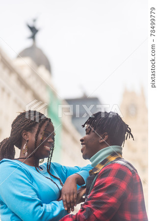 Black couple in love, in the city. Looking at each other. 78499779