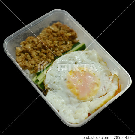 Fried eggs and minced pork in a plastic box on back blackground. Fried eggs and minced pork in a plastic box on back blackground. 78501432