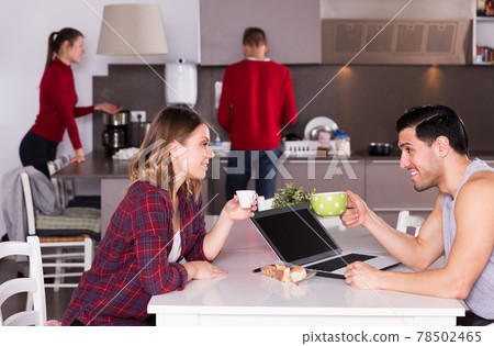 Couple talking in hostel kitchen 78502465