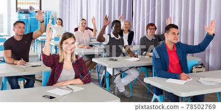 Student group with hands raised 78502769