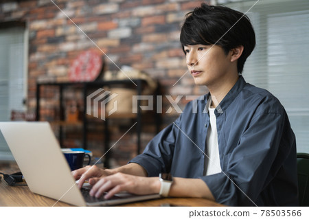 A young man working on a laptop A young man working on a laptop 78503566