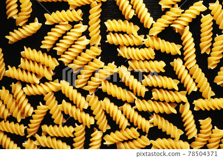 Pasta on a black background. Texture 78504371