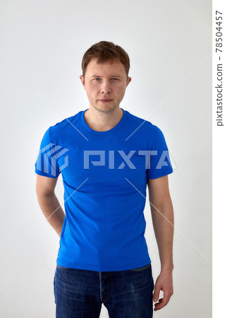 Young man in casual outfit standing on white background Young man in casual outfit standing on white background 78504457