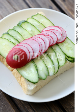 Cucumber and radish open sandwich with topping 78505873