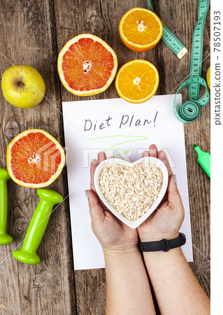 Female hands hold a plate of oatmeal Female hands hold a plate of oatmeal 78507193