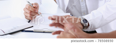 Male doctor hand hold silver pen filling patient history list 78508930