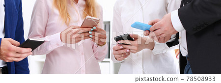 Group of people look at phones in arms 78508933