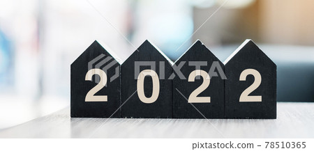 2022 Happy New Year with wooden Home model on table office. New House, Financial, Property insurance and real estate concepts 2022 Happy New Year with wooden Home model on table office. New House, Financial, Property insurance and real estate concepts 78510365