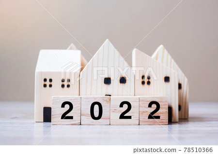 2022 Happy New Year with house model on table wooden background. Banking, real estate, investment, financial, savings and New Year Resolution concepts 78510366