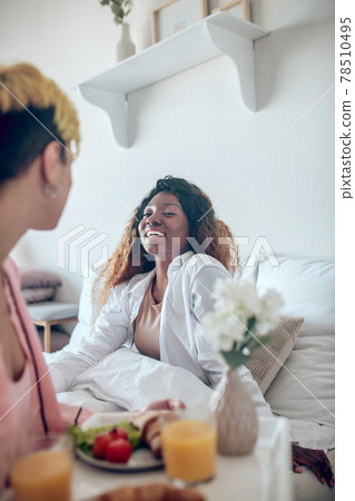 Joyful african american woman and girlfriend with food tray Joyful african american woman and girlfriend with food tray 78510495