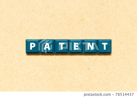Tile alphabet letter in word patent on wood background 78514437
