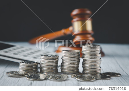 Old wood Judge hammer with stacking coins in close-up and coins stack the table wood background, Used for adjudication and Justice. Old wood Judge hammer with stacking coins in close-up and coins stack the table wood background, Used for adjudication and Justice. 78514918