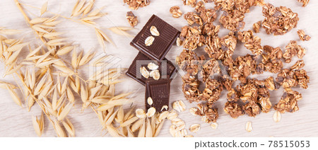 Ears of oat, flakes, granola and chocolate containing iron and fiber, healthy snack concept 78515053