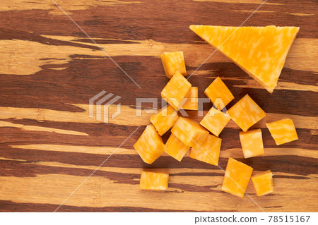 Cubes of marble cheese on wooden background. Cubes of marble cheese on wooden background. 78515167