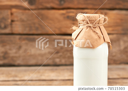 Bottle of healthy milk on wooden background. Bottle of healthy milk on wooden background. 78515303