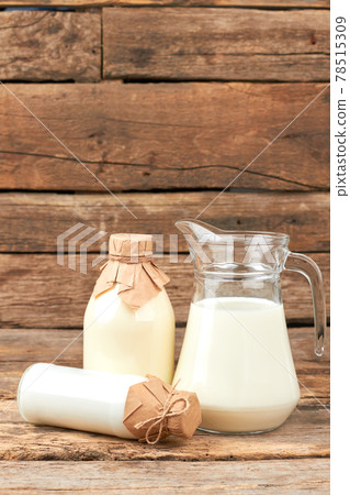 Cow milk in vintage style bottles. 78515309