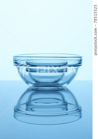 Transparent bowls on reflective surface. 78515525