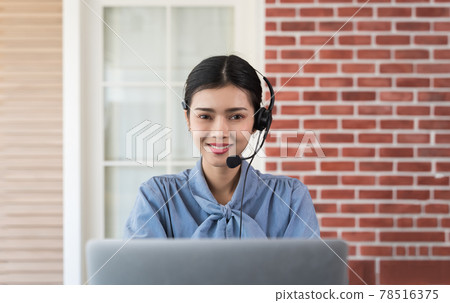 Professional call center agent Talking to customers with headsets while She's working from home are assisting remote customers and consulting client by remortly in call center and remotely concept. 78516375