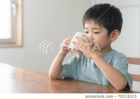 A boy taking a break with a drink A boy taking a break with a drink 78518323