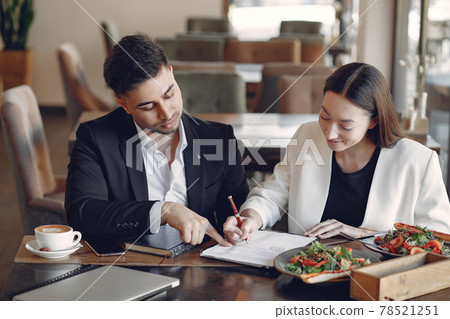 Stylish businessman working in a office and use the phone Stylish businessman working in a office and use the phone 78521251