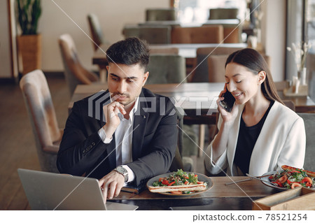 Stylish businessman working in a office and use the phone Stylish businessman working in a office and use the phone 78521254