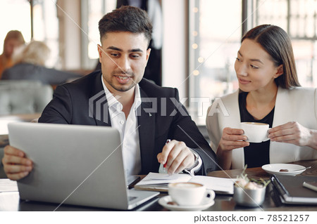 Stylish businessman working in a office and use the phone 78521257
