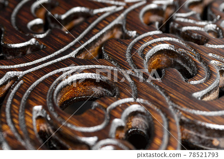 Figured carving on shiny rosewood, beautiful macro Figured carving on shiny rosewood, beautiful macro 78521793