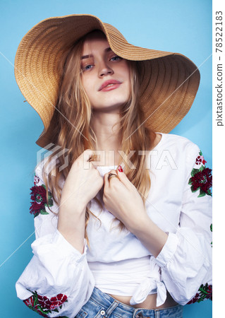 lifestyle people at summer vacation concept. young pretty smiling blond girl with long hair wearing lot of jewelry rings, sunglasses, hat posing cheerful on blue background lifestyle people at summer vacation concept. young pretty smiling blond girl with long hair wearing lot of jewelry rings, sunglasses, hat posing cheerful on blue background 78522183