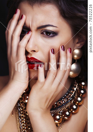 beauty rich brunette woman with a lot of jewellery, hispanic curly lady posing very emotional 78522216